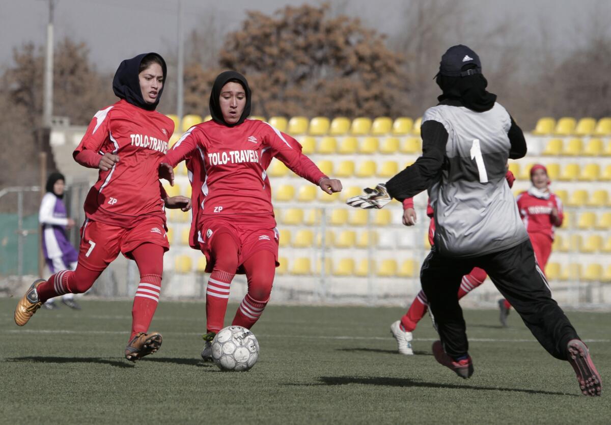 Afghan female soccer players compete in a match at the Afghanistan Football Federation (AFF) stadium 