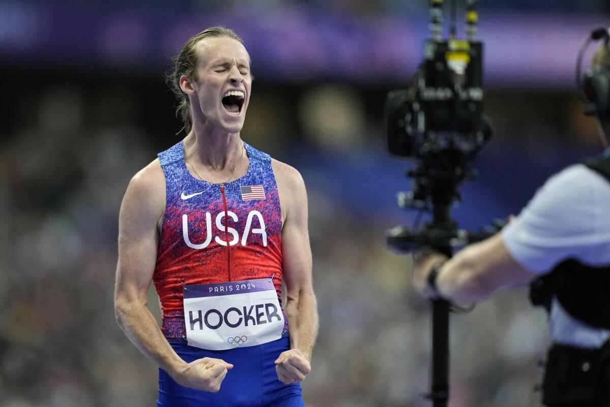 Cole Hocker celebrates after winning the gold medal in the men's 1,500 meters.