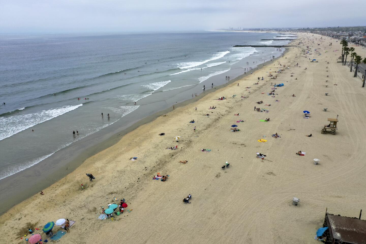 Visitors enjoy the sand in Newport Beach