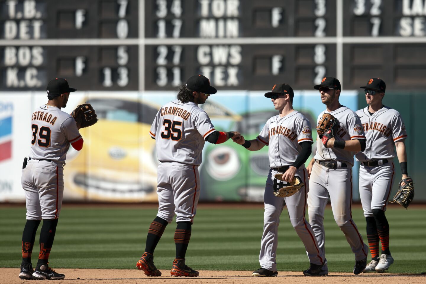 San Francisco Giants players celebrate their victory over the Oakland Athletics in a baseball game, Sunday, Aug. 7, 2022, in Oakland, Calif. (AP Photo/D. Ross Cameron)