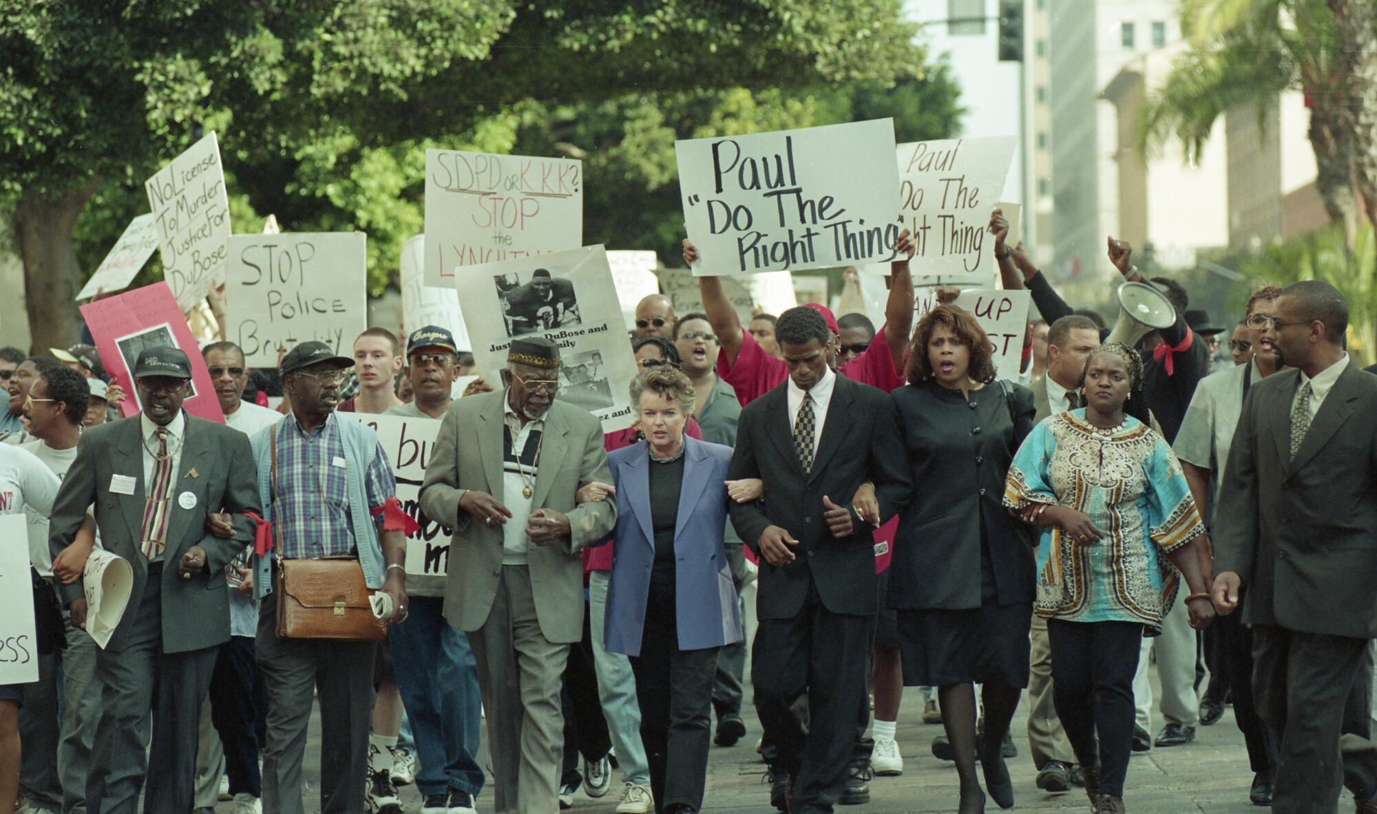 Scenes of a vigil and protest of the fatal police shooting of Demetrius DuBois in 1999