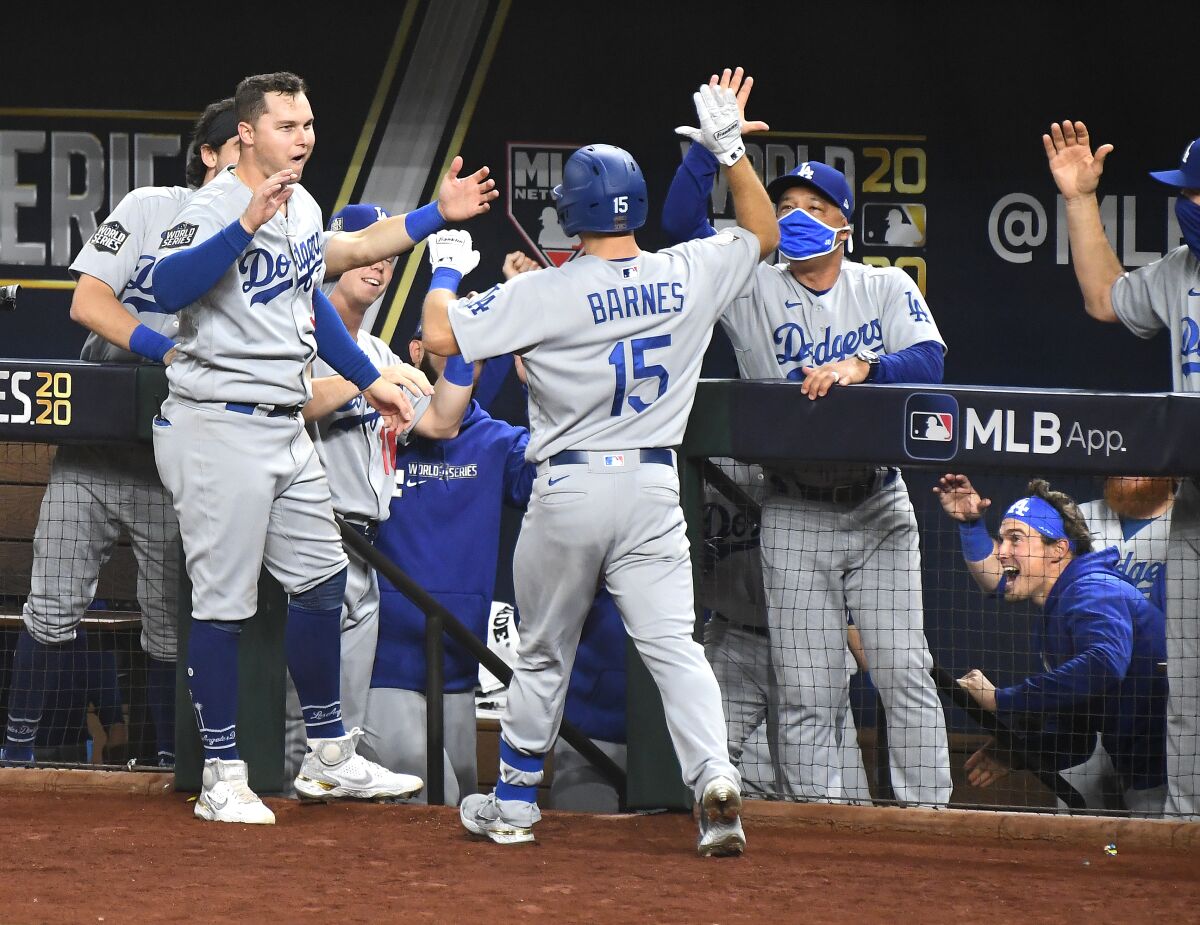 Dodgers manager Dave Roberts greets Austin Barnes after Barnes homered in the sixth inning of Game 3.