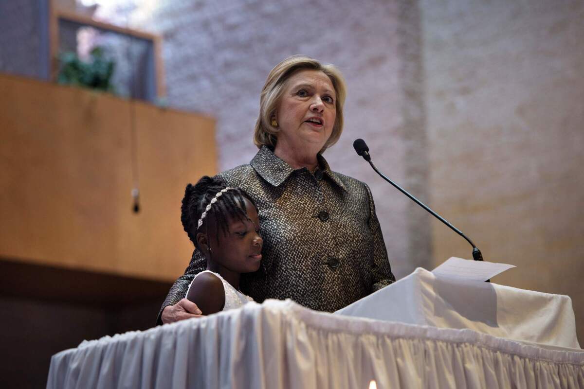 Hillary Clinton speaks with Zianna Oliphant at her side on Sunday at a church in Charlotte, N.C.
