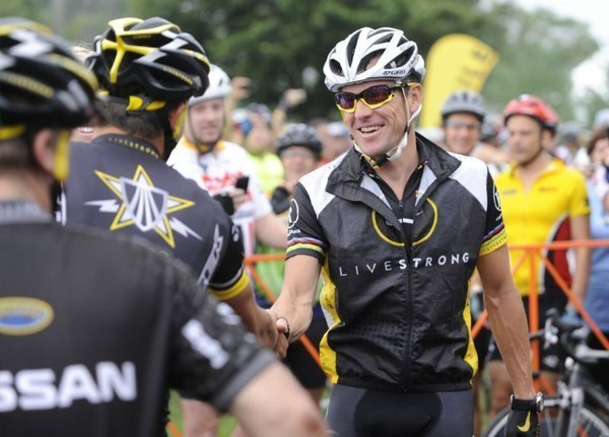 Lance Armstrong greets fellow riders before the start of his Livestrong Challenge 10K ride for cancer in Blue Bell, Pa. in 2010.