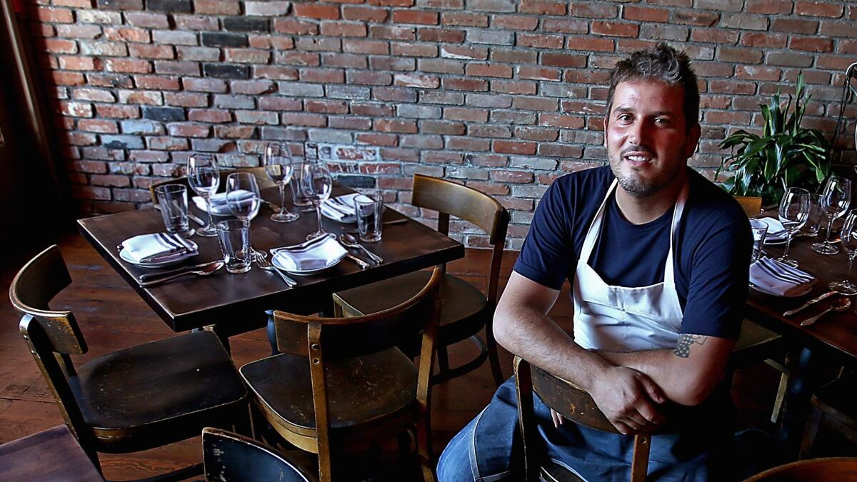 Chef Perfecto Rocher is shown in the dining room of Los Angeles restaurant Smoke.Oil.Salt. He says he’s going to take a month to return to Spain, visit his mother and recharge his culinary batteries before he returns to Los Angeles in the fall.