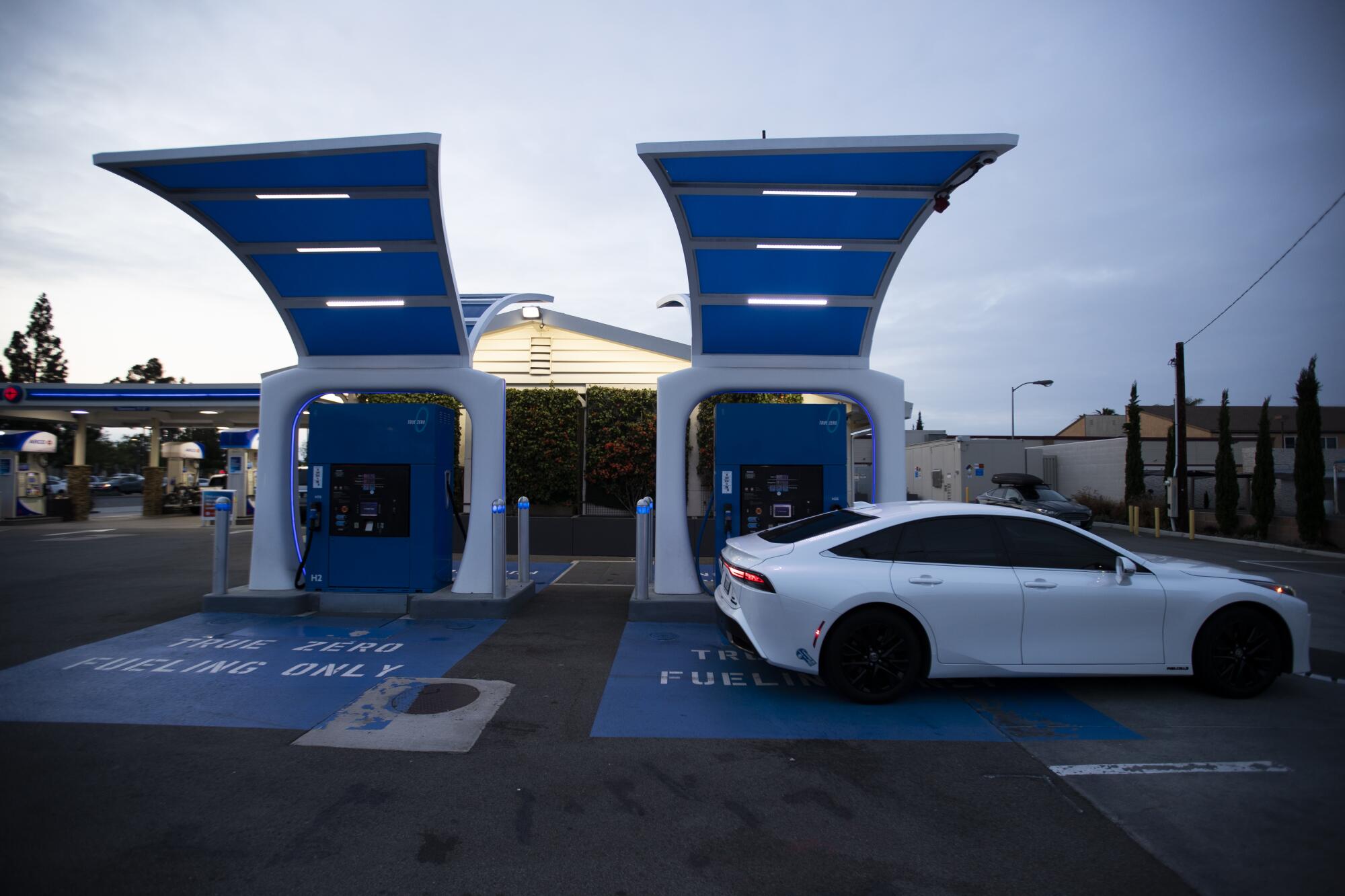 A white car at a hydrogen filling station.