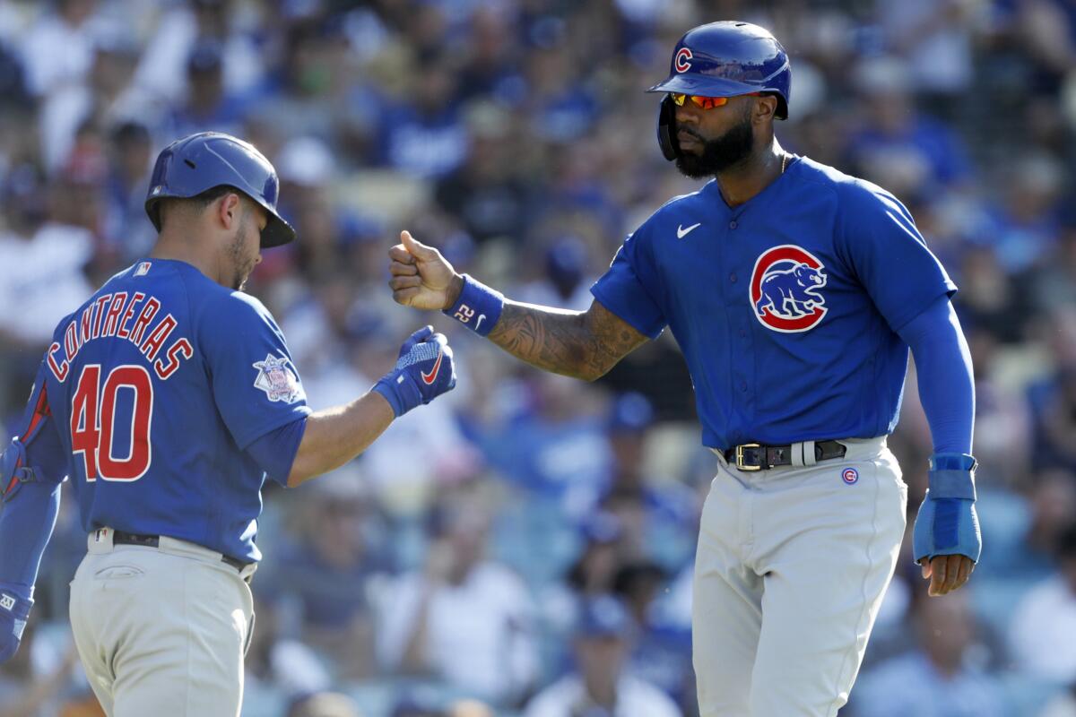 Chicago's Jason Heyward, right, is congratulated by teammate Wilson Contreras after scoring a run in the fifth inning.