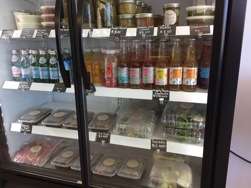 The grab-and-go refrigerator case at Ranch 45 in Solana Beach features housemade condiments, side dishes and locally bottled beverages.