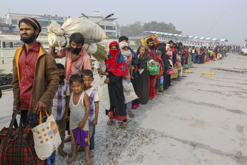 Rohingya refugees headed to the Bhasan Char island prepare to board navy vessels from the south eastern port city of Chattogram, Bangladesh, Monday, Feb.15,2021. Authorities sent a fourth group of Rohingya refugees to the newly developed island in the Bay of Bengal on Monday amid calls by human rights groups for a halt to the process. (AP Photo)