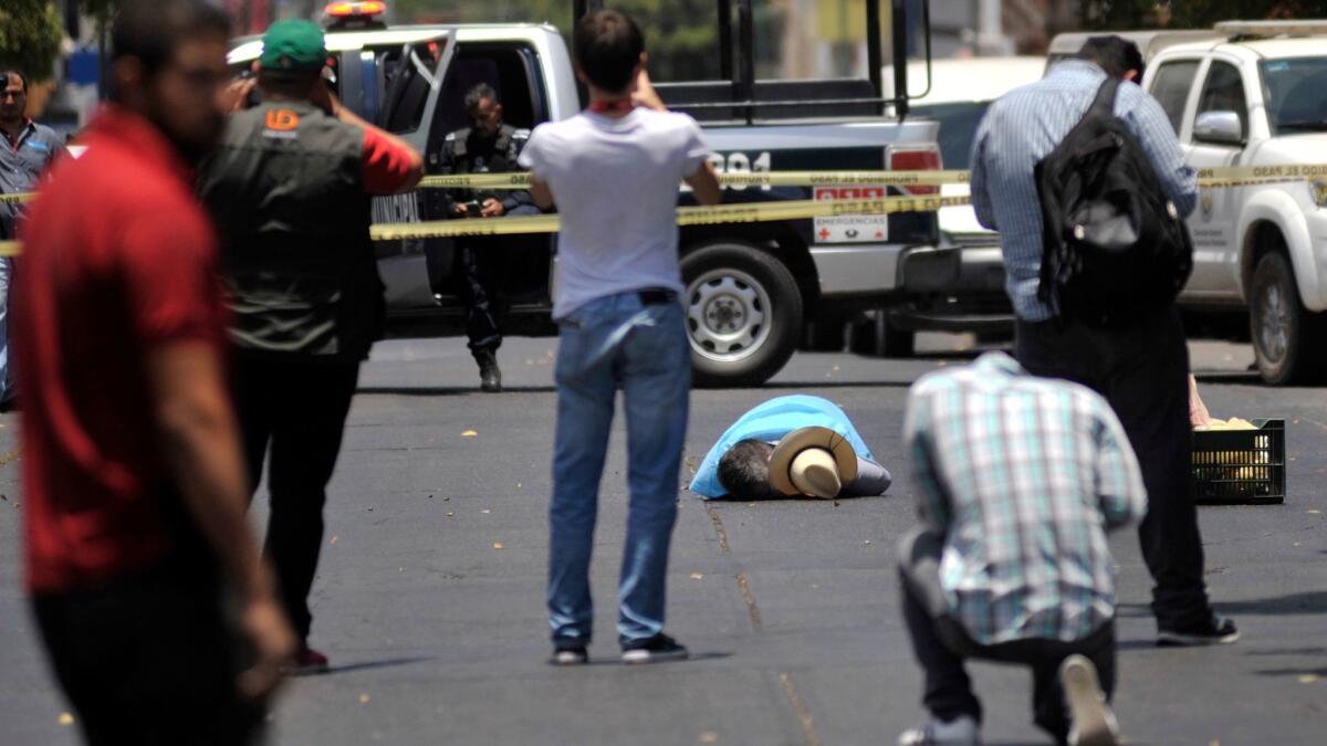 People take photos of slain journalist Javier Valdez on May 15, 2017, in Culiacan, Mexico. He co-founded the newspaper Riodoce and was a legendary chronicler of drug trafficking in Sinaloa state.
