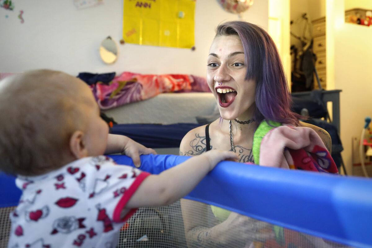 Mckenzie Trahan plays with her daughter Ann at home