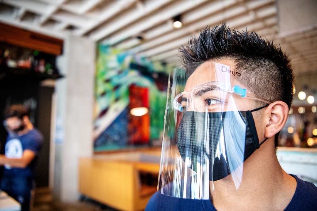 Christopher Gonzalez, along with other employees at Guerrilla Taco, wears protective gear.