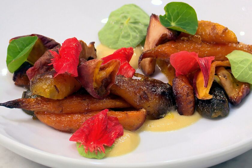 Chef Ari Taymor, chef and co-owner of Alma restaurant in Los Angeles, demonstrates a kitchen technique in the Los Angeles Times kitchen — a warm salad of roasted carrots and chanterelles that's on Alma's tasting menu and has been a standard, in various iterations, for the last two of Alma's three years. Get the recipe.