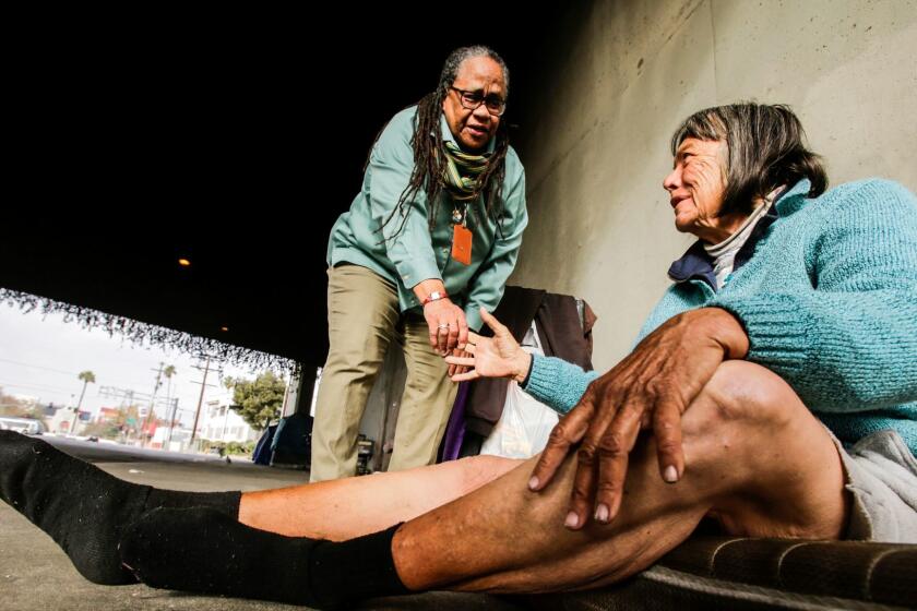 Jeanette Rowe meets Beverly Walker, 76, on 39th Street under the 110 Freeway in Los Angeles. Rowe, the longtime head of outreach for the Los Angeles Homeless Services Authority, is retiring.
