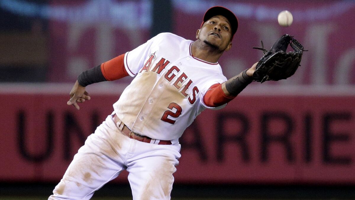 Angels shortstop Erick Aybar catches a fly ball hit by Rockies third baseman Nolan Arenado during the 10th inning of a game on May 13.