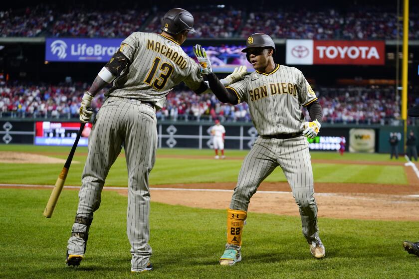 San Diego Padres right fielder Juan Soto celebrates his two-run home run with Manny Machado during the fifth inning in Game 4 of the baseball NL Championship Series between the San Diego Padres and the Philadelphia Phillies on Saturday, Oct. 22, 2022, in Philadelphia. (AP Photo/Matt Slocum)
