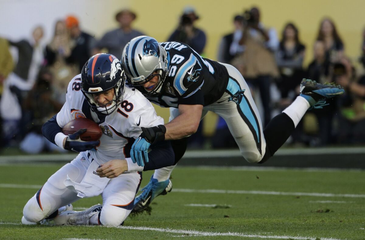 Denver Broncos quarterback Peyton Manning (18) is tackled by Carolina Panthers linebacker Luke Kuechly in Super Bowl 50.
