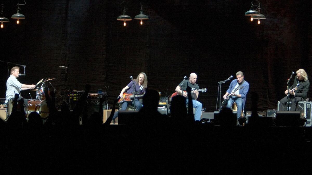 The Eagles, shown during a 2014 concert at the Forum in Inglewood: Don Henley, left, Timothy B. Schmit, Bernie Leadon, the late Glenn Frey and Joe Walsh. Remaining band members will return to playing concerts for a pair of new festivals.