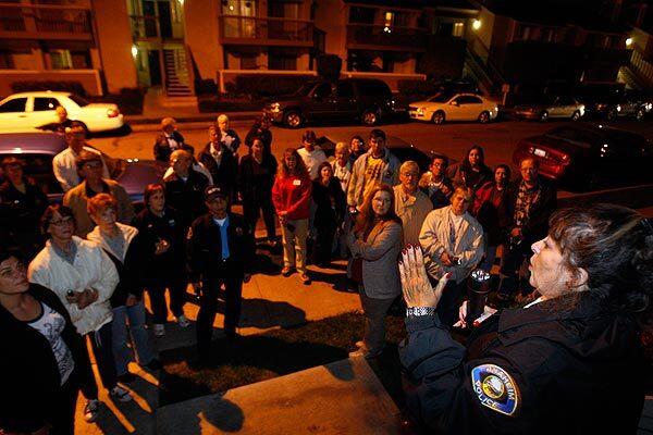 Anaheim Police Senior Crime Prevention Specialist Susie Schmidt, right, gathers Anaheim residents before embarking on a walk along Beach Boulevard in Anaheim. Prostitution is a problem for the residents of the Cobblestone apartments and others along Beach Boulevard in Anaheim, so with the help of the Anaheim Police Department, residents took it into their own hands by walking through their neighborhood with flashlights.