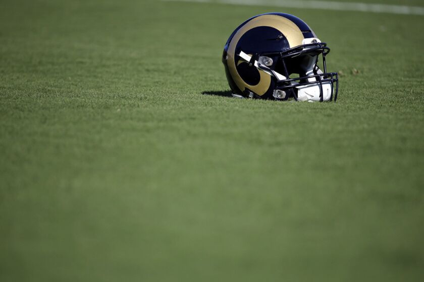 A St. Louis Rams helmet sits on the turf during training camp at the NFL football team's practice facility on Tuesday.