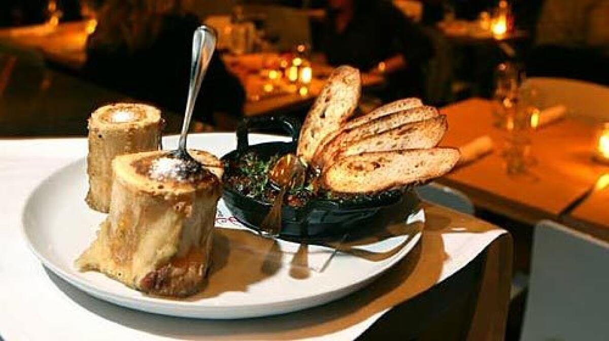 The luscious interior of the roasted beef marrow is of ready to be scooped out with a small spoon. On the side is an oxtail jam, the shredded meat cooked and reduced until its butter tender.