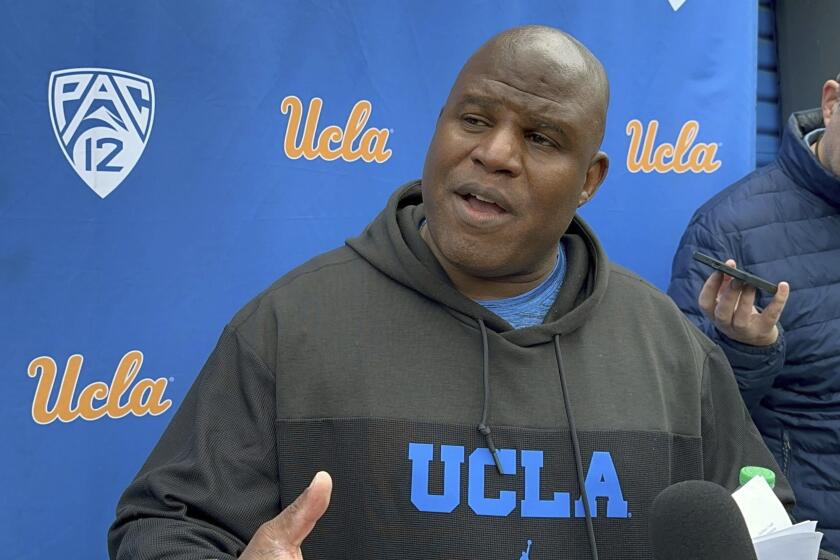 UCLA associate head coach and offensive coordinator Eric Bieniemy speaks with the reporters.