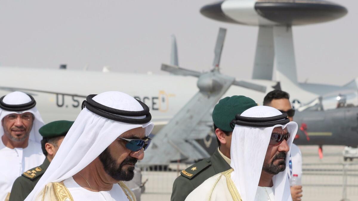 Ruler of Dubai Sheikh Mohammed bin Rashid Maktoum, left, attends the Dubai Air Show on Sunday.