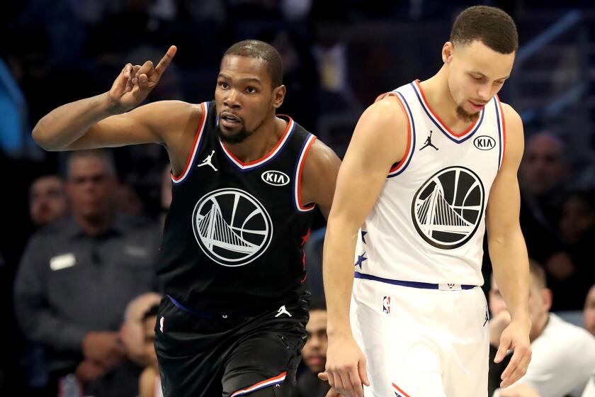 Kevin Durant of Team LeBron and Stephen Curry of Team Giannis have different reactions to a play during the NBA All-Star game.