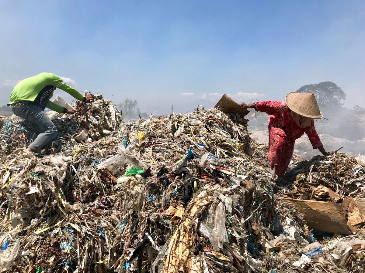 Scavengers pick through a mound of rubbish in Bangun.