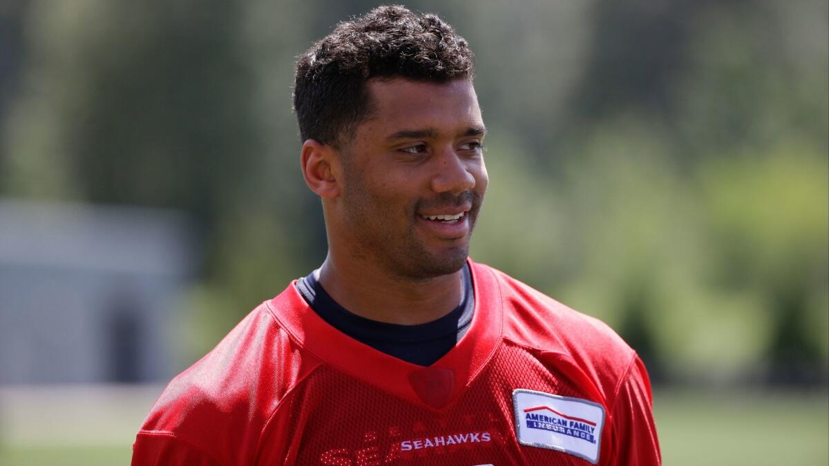 Seattle quarterback Russell Wilson walks off the field following practice on June 2.