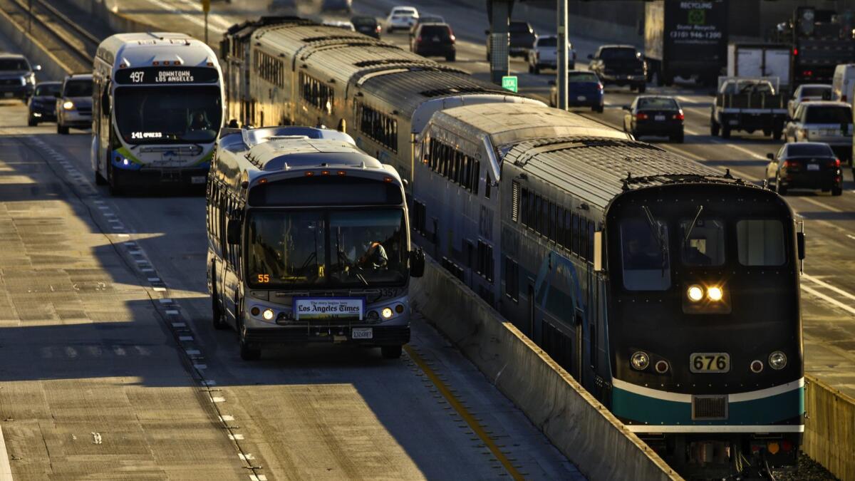 A Metrolink train travels along the 10 Freeway toward Union Station. State grants announced Thursday aim to improve rail and bus services.