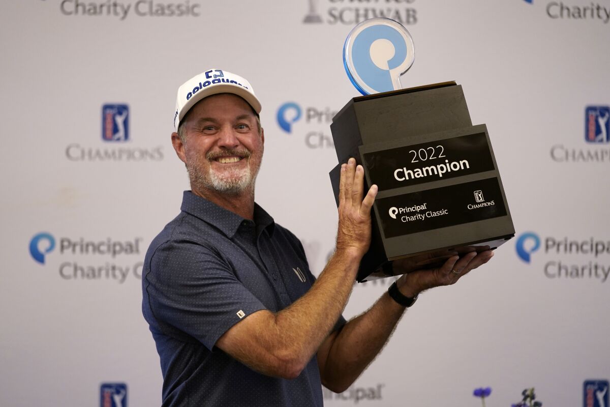 Jerry Kelly holds the trophy after winning the PGA Tour Champions Principal Charity Classic golf tournament, Sunday, June 5, 2022, in Des Moines, Iowa. (AP Photo/Charlie Neibergall)