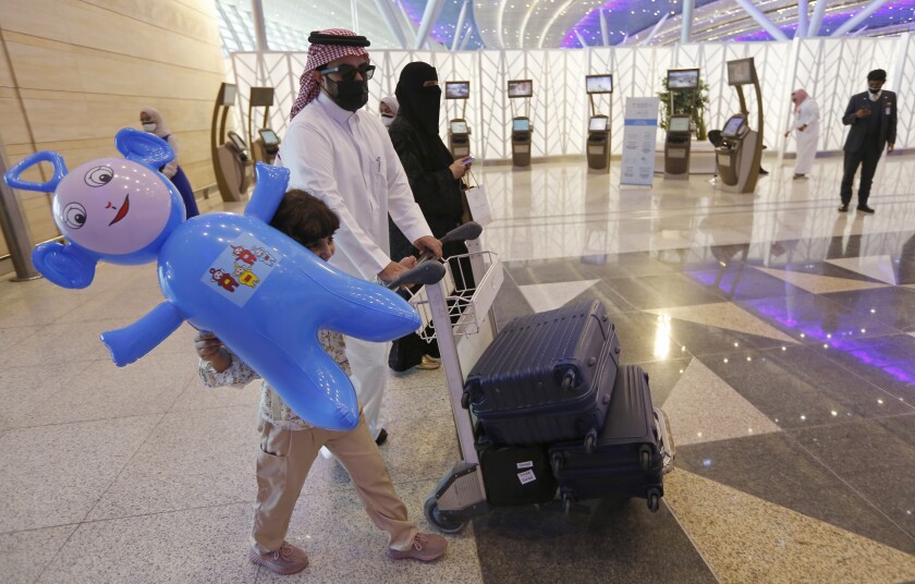 Saudi passengers enter King Abdulaziz International Airport in Jiddah, Saudi Arabia, Monday, May 17, 2021. Vaccinated Saudis will be allowed to leave the kingdom for the first time in more than a year as the country eases a ban on international travel that had been in place to try and contain the spread of the coronavirus and its new variants. (AP Photo/Amr Nabil)