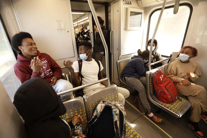 Palisades Charter High School students ride an Metro E line train on April 21.