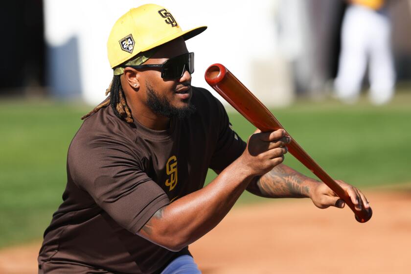 Peoria, AZ - February 16: Eguy Rosario bunts during Padres spring training workouts at the Peoria Sports Complex on Friday, Feb. 16, 2024 in Peoria, AZ. (Meg McLaughlin / The San Diego Union-Tribune)