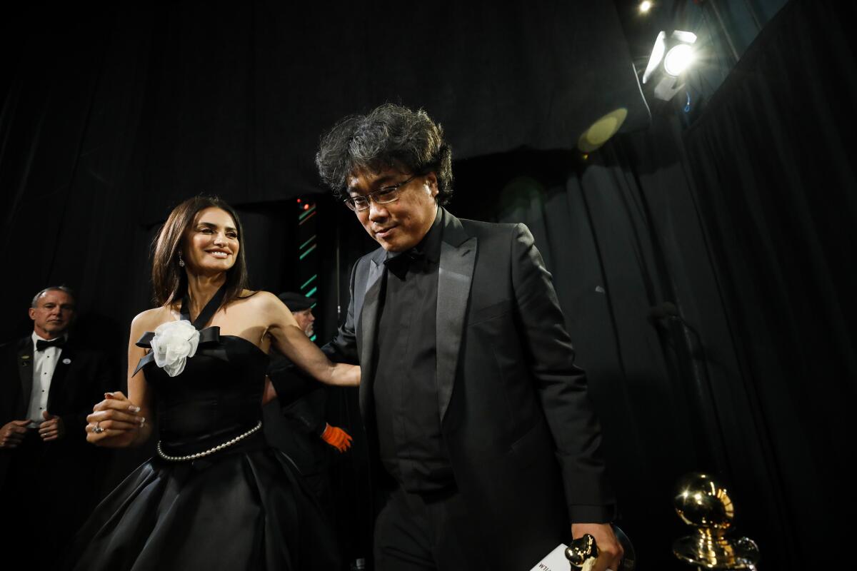 Penelope Cruz and Bong Joon Ho winner of the international feature Oscar for “Parasite” backstage at the 92nd Academy Awards.