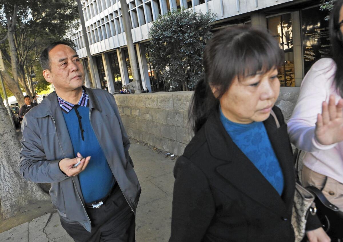 Xiyong Wu, left, and Meinan Yin, leave the courthouse after Javier Bolden was sentenced to life in prison for killing their daughter, Ying Wu, and Ming Qu, both graduate students at USC.