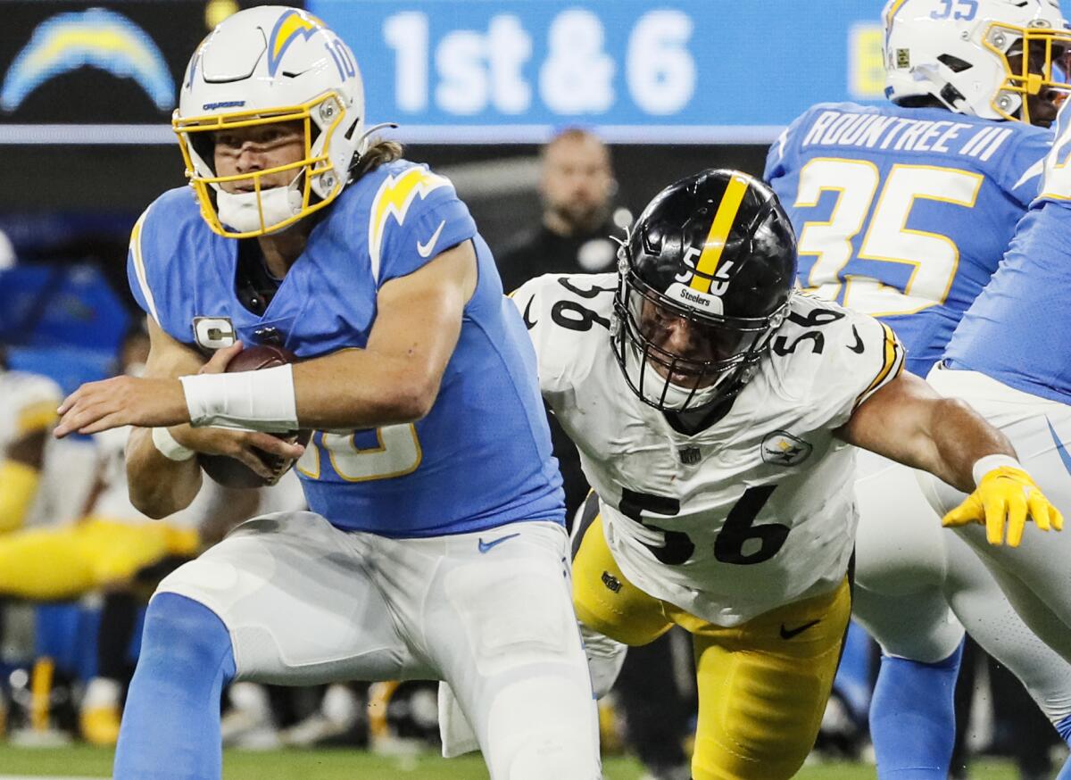 Chargers quarterback Justin Herbert  is sacked by Pittsburgh Steelers outside linebacker Alex Highsmith.