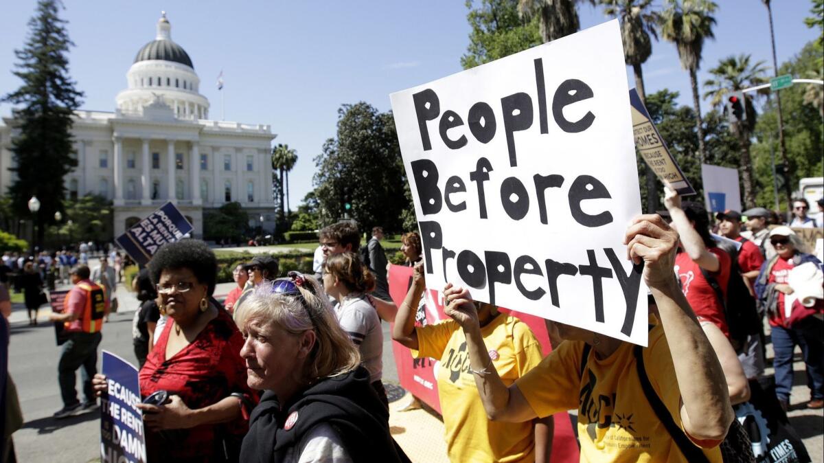 Supporters of a rent control initiative march near the Capitol in April. Backers of the initiative say they have collected enough signatures to allow voters to decide whether to repeal a 1995 law that restricts rent control.