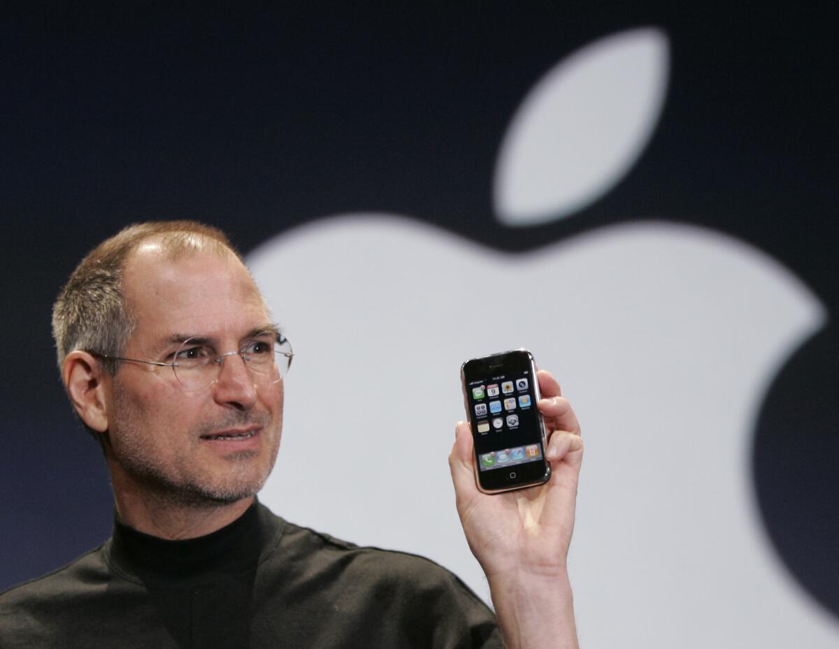 Apple CEO Steve Jobs holds up an Apple iPhone at the MacWorld Conference in San Francisco on Jan. 9, 2007. 