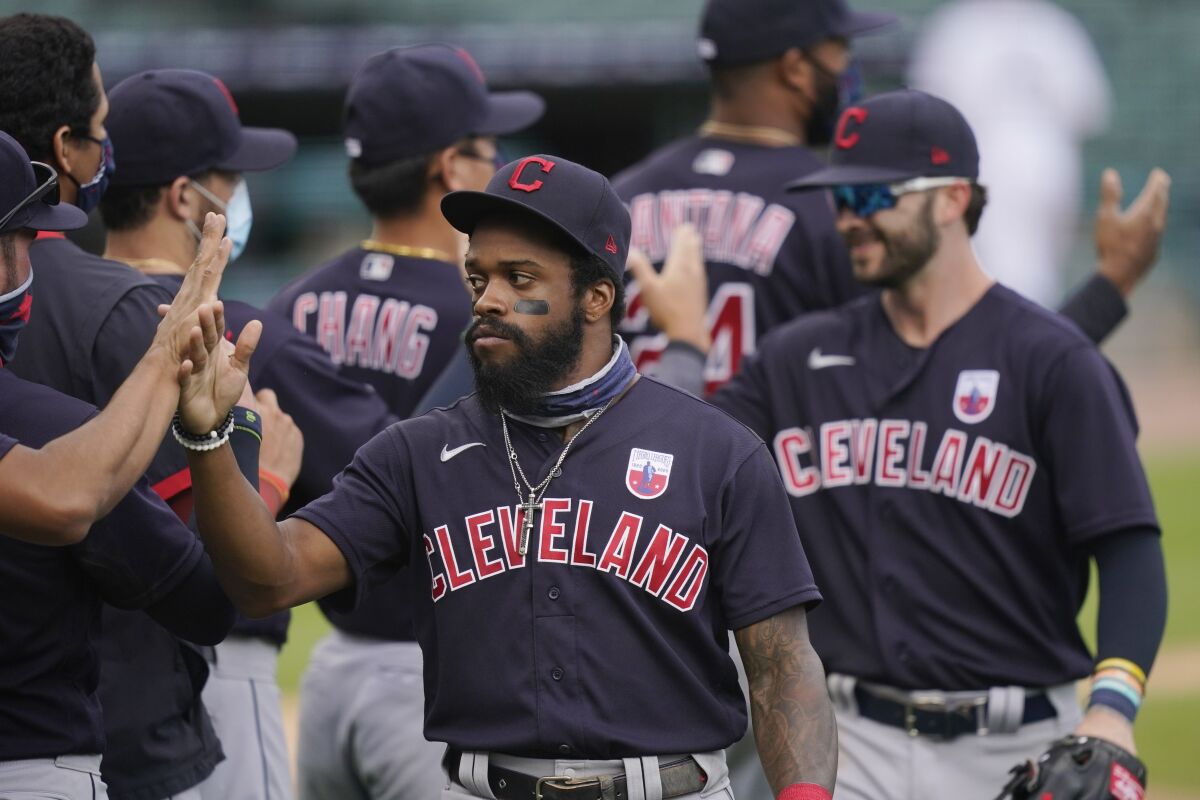 Cleveland Indians center fielder Delino DeShields greets teammates after their 8-5 over the Detroit Tigers in a baseball game, Sunday, Aug. 16, 2020, in Detroit. (AP Photo/Carlos Osorio)