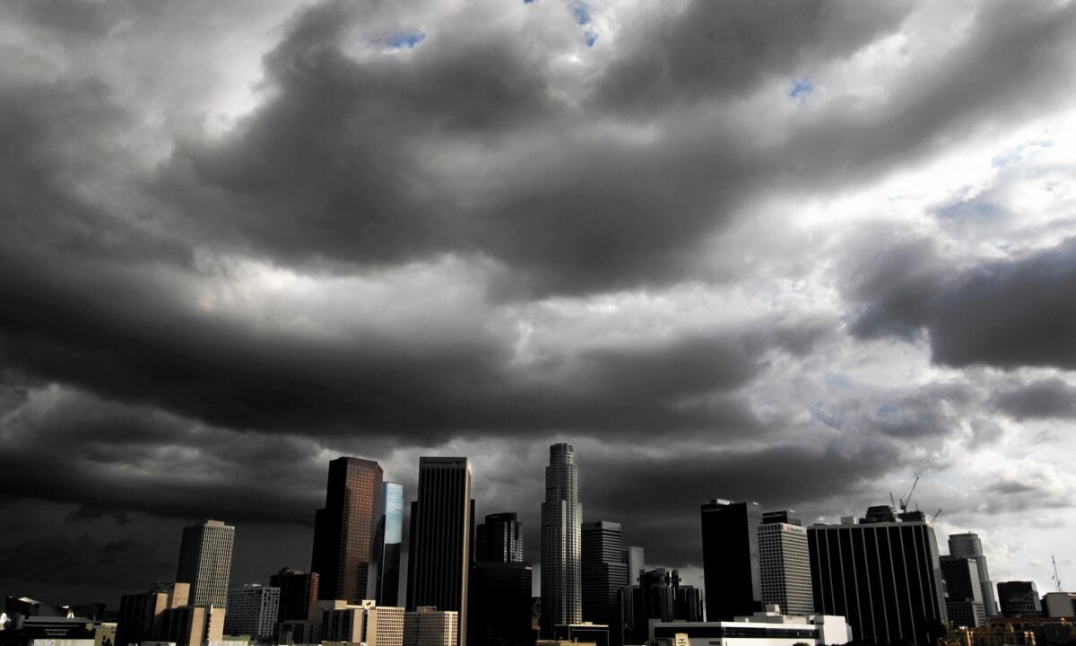 Storm clouds drift over downtown Los Angeles in October; flooding caused by a mattress blocking a storm drain in Boyle Heights that month caused officials to reassess preparations for El Niño.