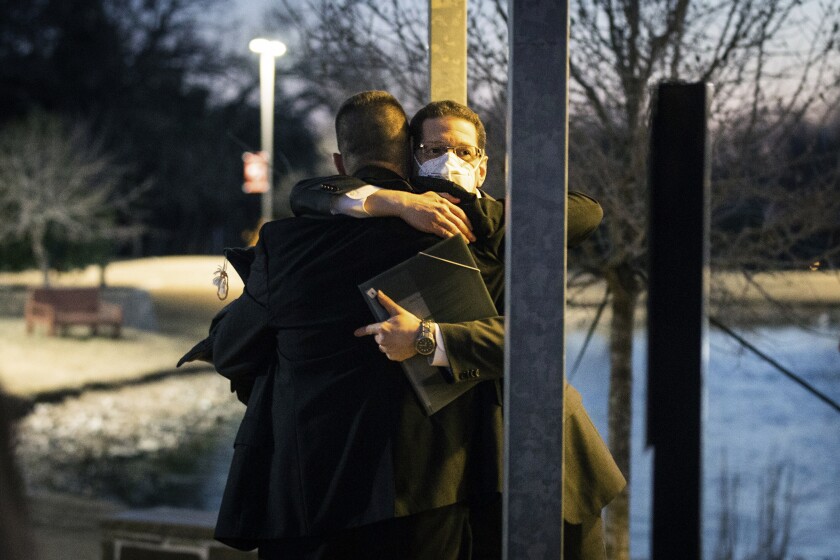 FILE - Congregation Beth Israel Rabbi Charlie Cytron-Walker, facing camera, hugs a man after a healing service Monday night, Jan. 17, 2022, at White's Chapel United Methodist Church in Southlake, Texas. Cytron-Walker was one of four people held hostage by a gunman at his Colleyville, Texas, synagogue on Saturday. (Yffy Yossifor/Star-Telegram via AP, File)