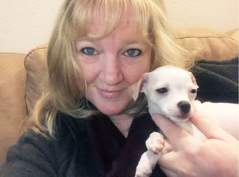 Angela Rowe with Bongo, one of the many pups she helped transition to an adoptive home.