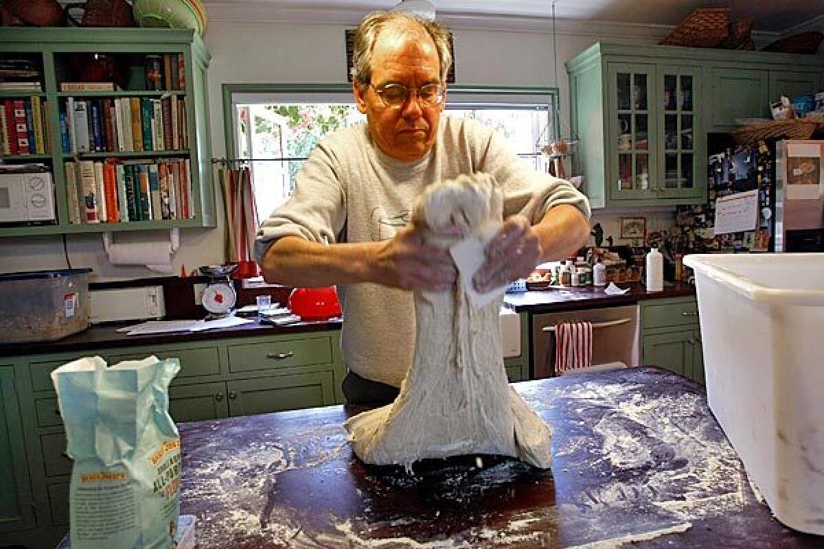 Mark Stambler stretches dough for loaves of pain au levain.