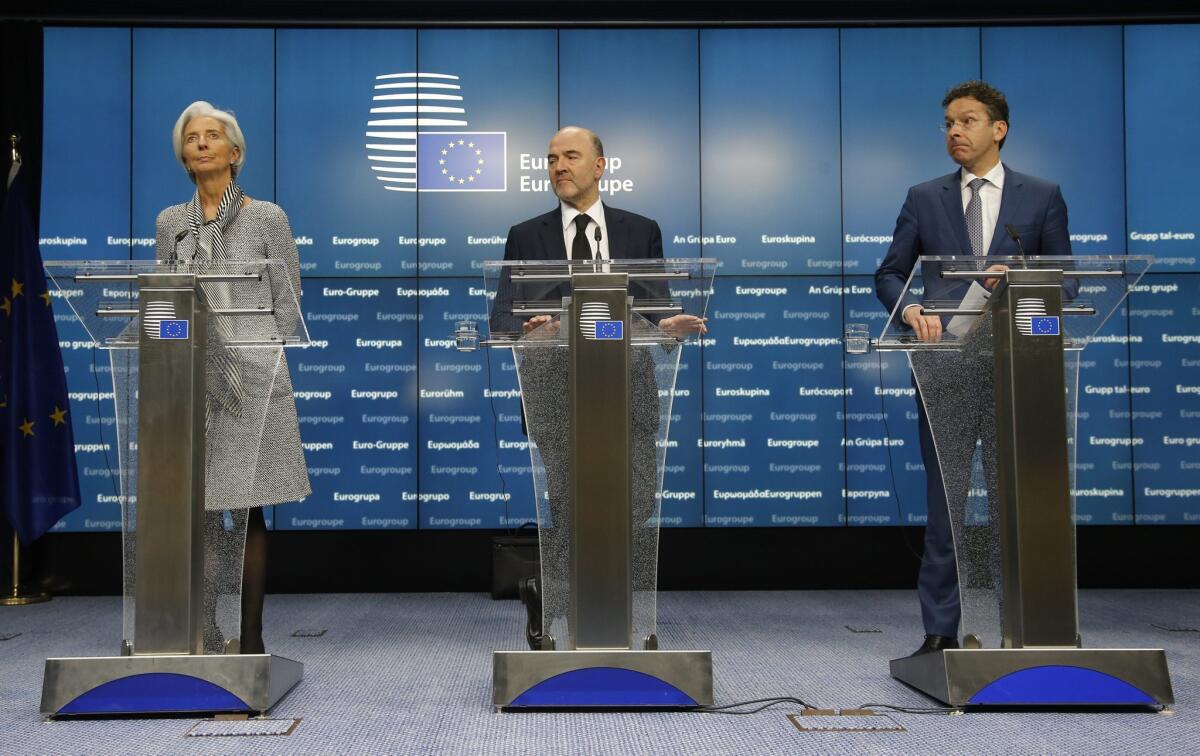 International Monetary Fund managing director Christine Lagarde, European Commissioner for Economic and Financial Affairs, Taxation and Customs, Pierre Moscovici, and Dutch Minister of Finance and President of the Council, Jeroen Dijsselbloem, give a press briefing at the end of a special Eurogroup meeting of Finance ministers, at the European Council headquarters, in Brussels, Belgium. U.S. stocks reached record highs after Greece reached an agreement with its eurozone partners on a four-month bailout extension.