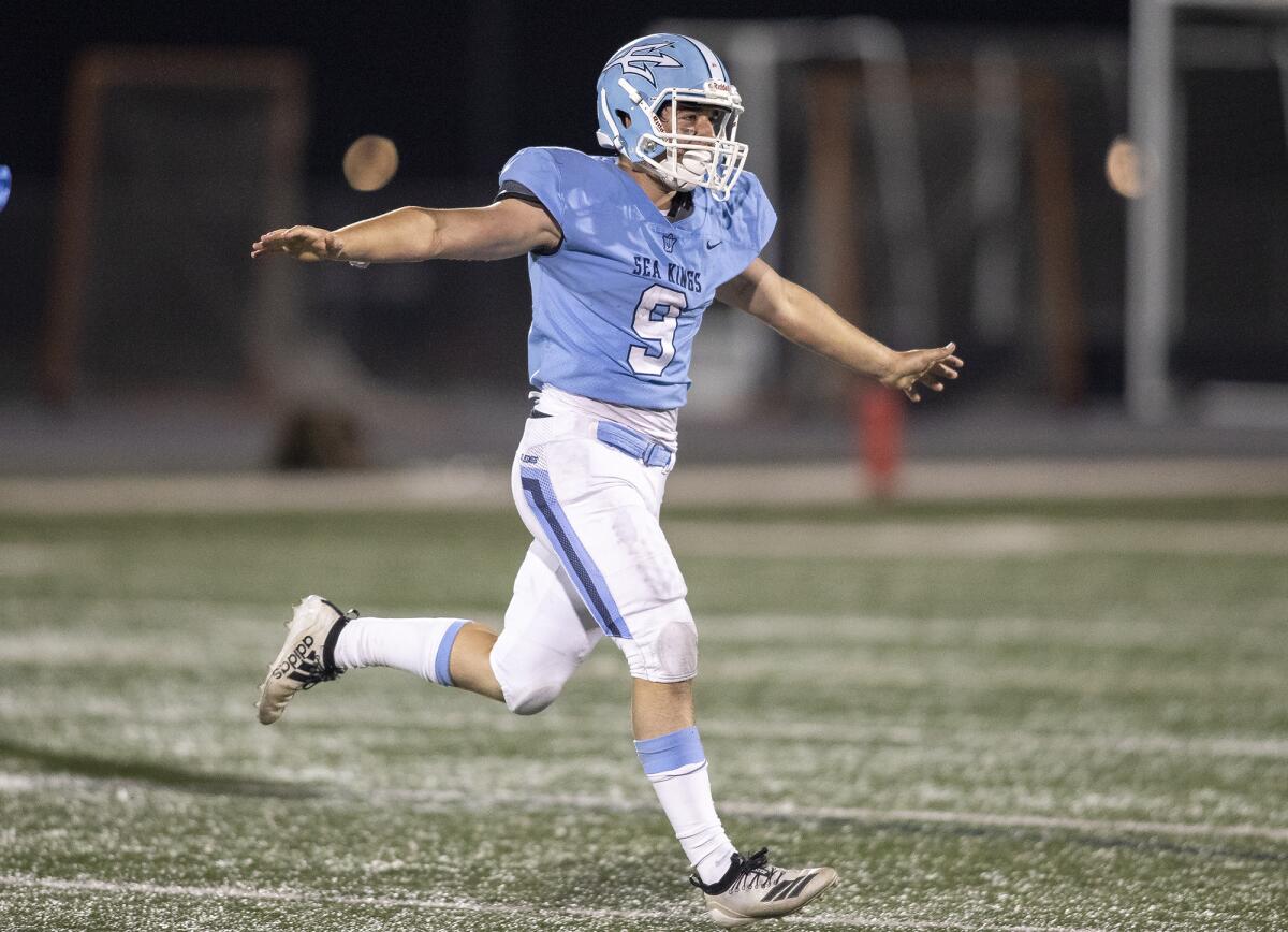 Corona del Mar's Mikey Wein celebrates after intercepting a pass during the Battle of the Bay football game on Friday.