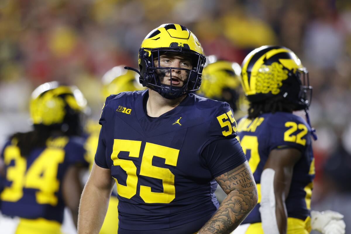 Michigan defensive lineman Mason Graham looks to the sideline during a game.