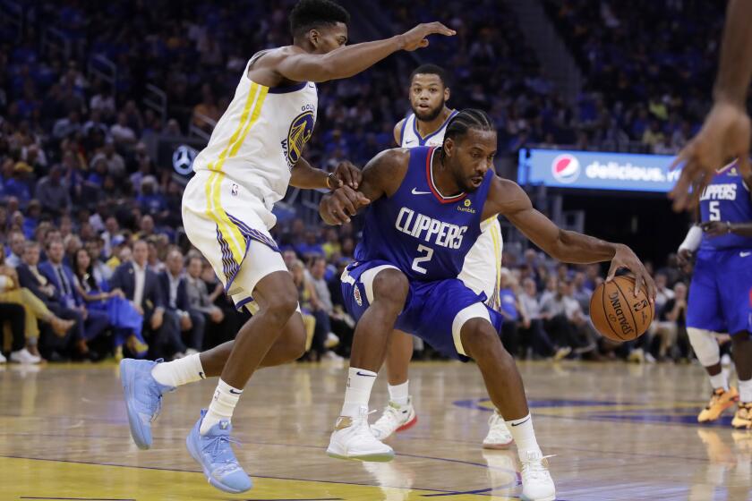 Los Angeles Clippers' Kawhi Leonard (2) drives the ball against Golden State Warriors' Glenn Robinson III, left, during the first half of an NBA basketball game Thursday, Oct. 24, 2019, in San Francisco. (AP Photo/Ben Margot)