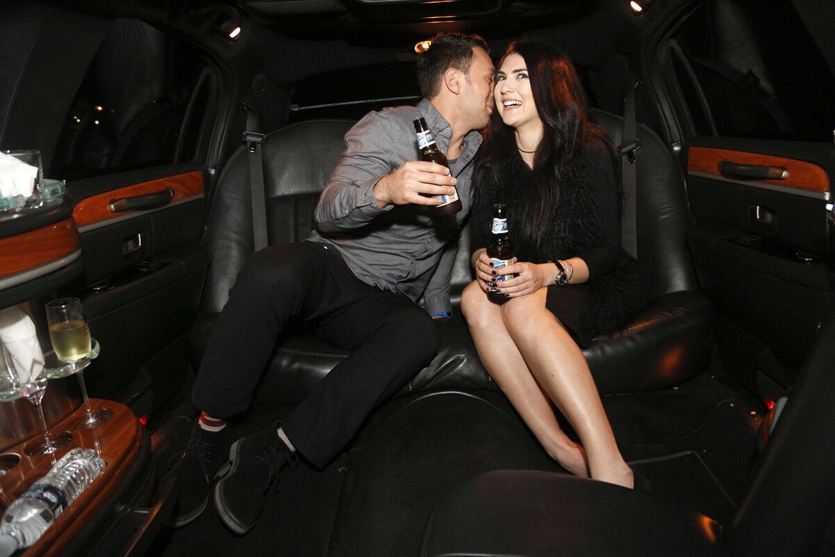Blind daters Scott Schindler and Zlata Sushchik have some fun in the limo while drinking Blue Moon Belgian White.(David Brooks / Union-Tribune)